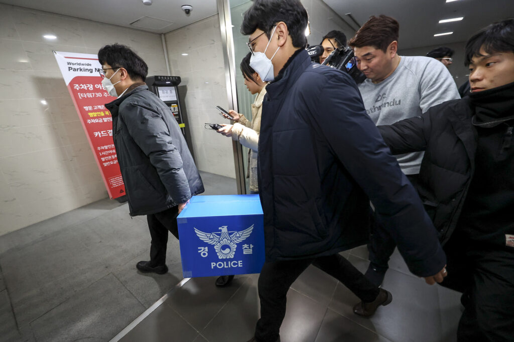 Police transporting seized documents out of Coupang's office